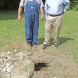 perry JR Perry Goodson and J.R. Denton look at one of 25 manholes to be replaced in a major sewer line upgrade set for Calhoun City.
