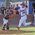 steele Calhoun City catcher Steele Liles attempts to apply the tag at home plate to Baldwyn's Reggie Richey. Photo by Joel McNeece
