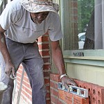 museum Herbert Dixon installs memorial bricks on the front of the Bruce Museum.
