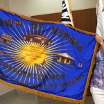 Denean flag Derma Town Clerk Deneen James shows the town's new flag while attending the MML convention in Biloxi.